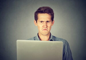 Frustrated-man-looking-at-laptop