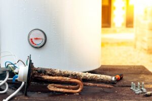 Boiler with pressure gauge and bright light in the background.