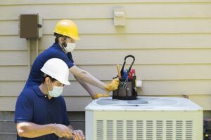 air-conditioner-techs-working-on-AC-cabinet